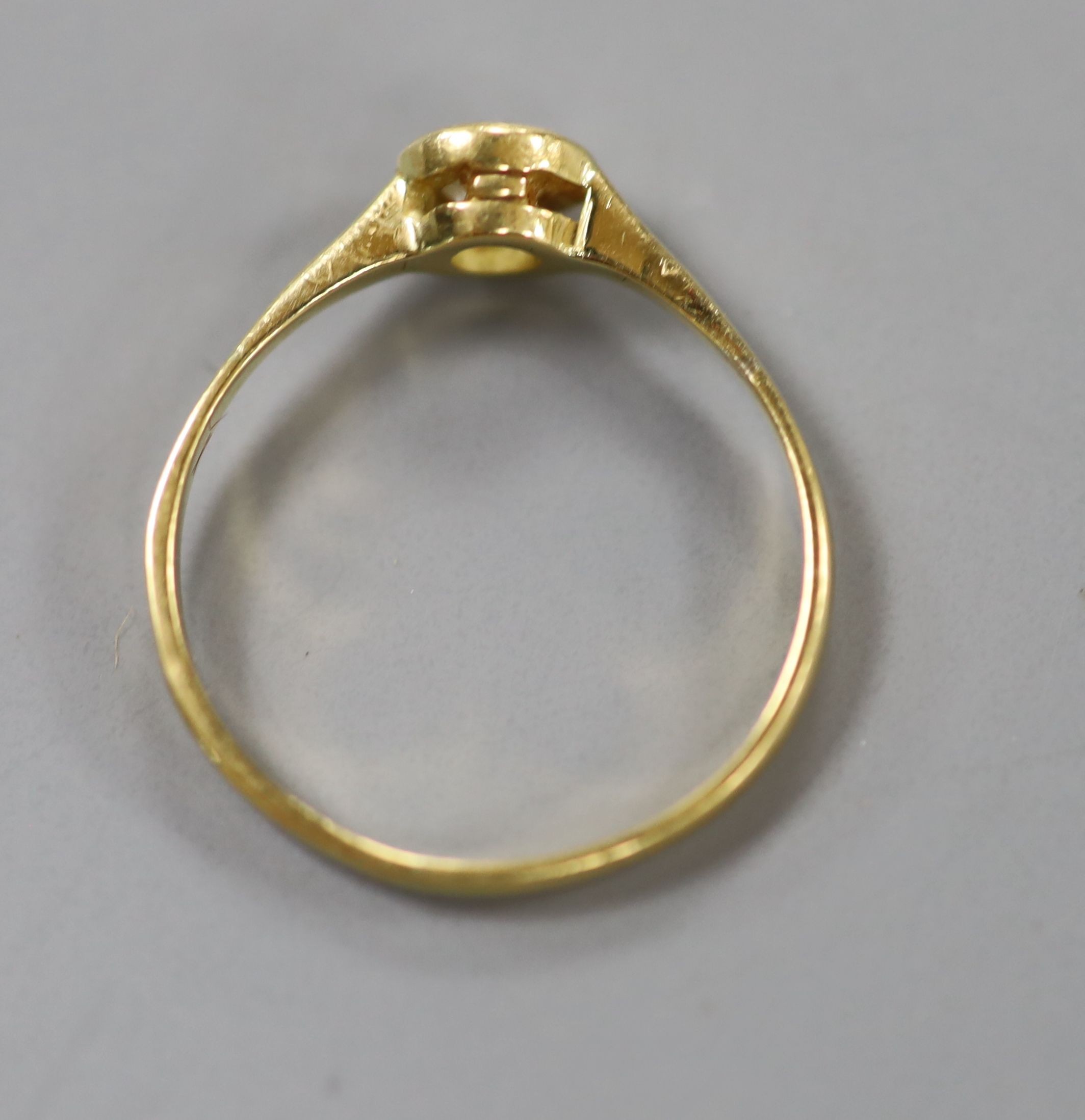 A yellow metal and collet set solitaire diamond ring, size P, gross weight 1.9 grams